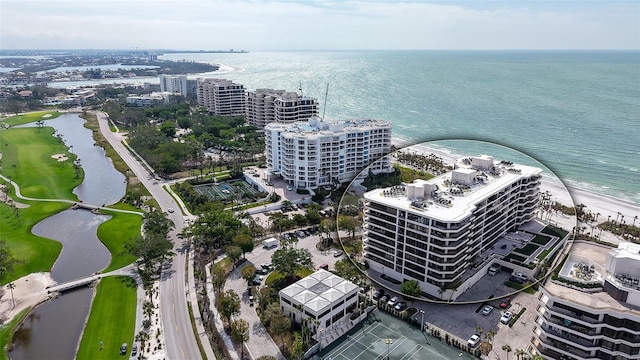 birds eye view of property featuring a water view and a city view