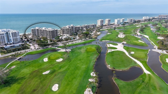 bird's eye view featuring a city view, view of golf course, and a water view