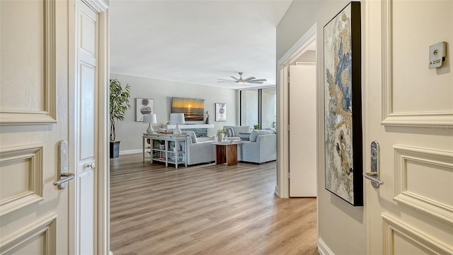 interior space featuring light wood-type flooring and baseboards