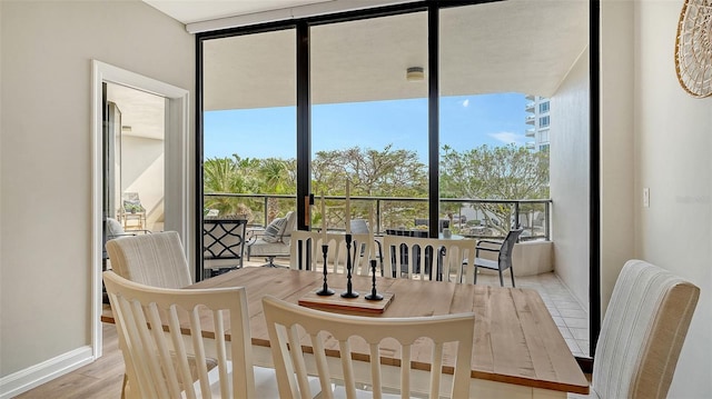 dining space with wood finished floors and baseboards