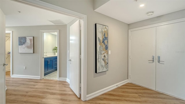 entrance foyer with light wood-style floors and baseboards