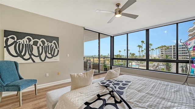 bedroom featuring light wood-type flooring, ceiling fan, and baseboards