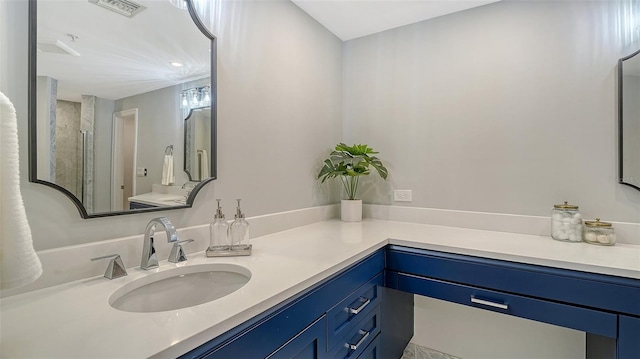 bathroom featuring visible vents, a shower, and vanity