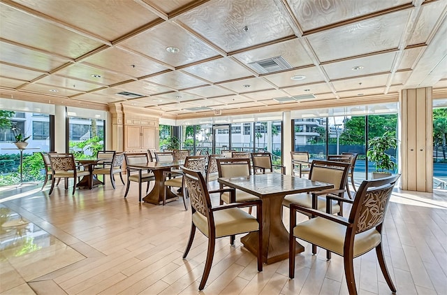 sunroom with visible vents, coffered ceiling, and a wealth of natural light