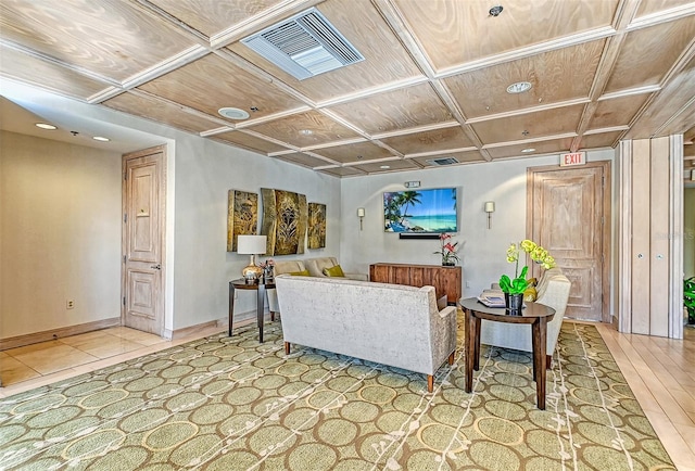 living room featuring coffered ceiling, visible vents, and baseboards