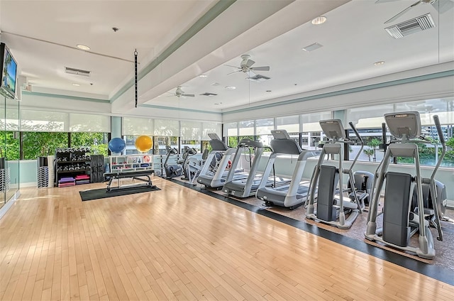 exercise room featuring a ceiling fan, wood-type flooring, and visible vents