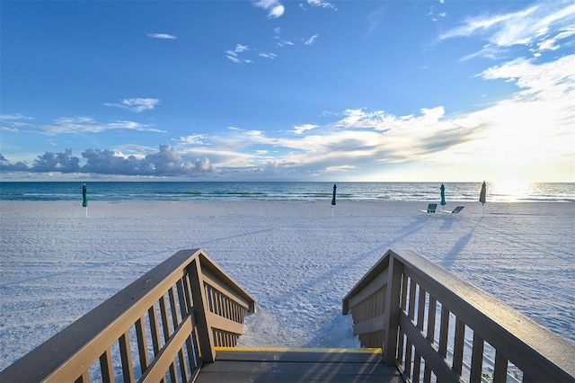 dock area featuring a water view and a beach view