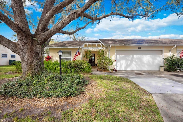 ranch-style home featuring a garage, driveway, and stucco siding