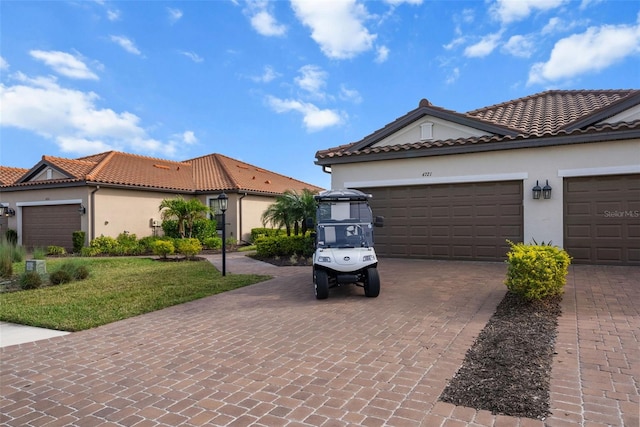 mediterranean / spanish home featuring a front lawn and a garage