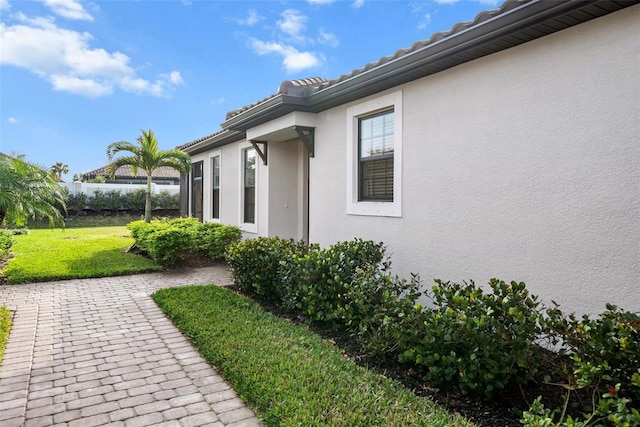 view of property exterior featuring a lawn