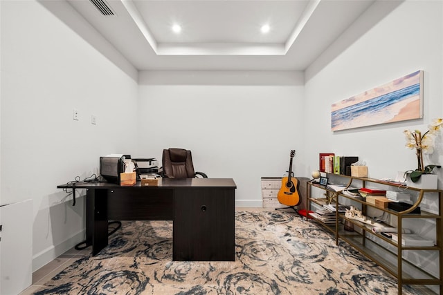 office space featuring a raised ceiling