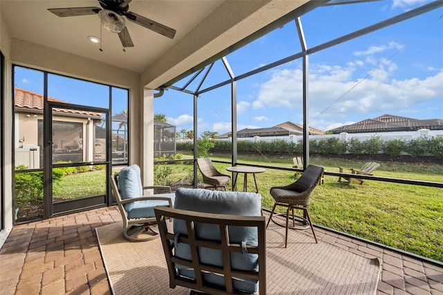 sunroom / solarium featuring ceiling fan
