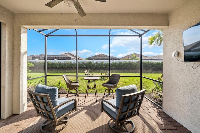 sunroom with ceiling fan and plenty of natural light