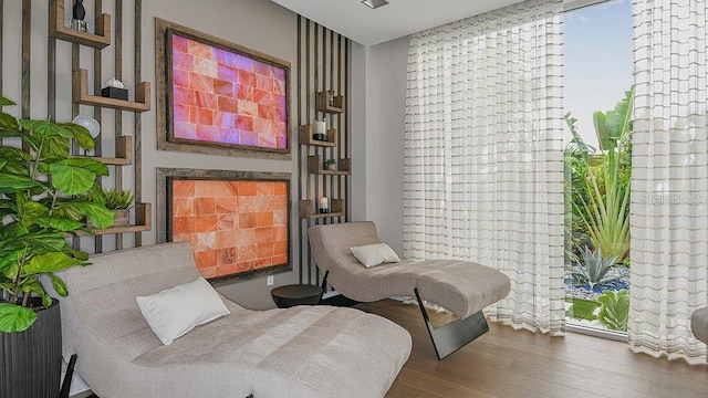 sitting room with wood-type flooring and a fireplace