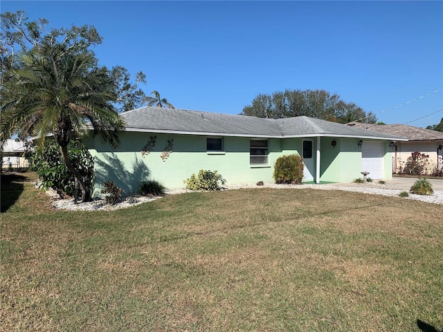 view of front facade featuring a front yard and a garage