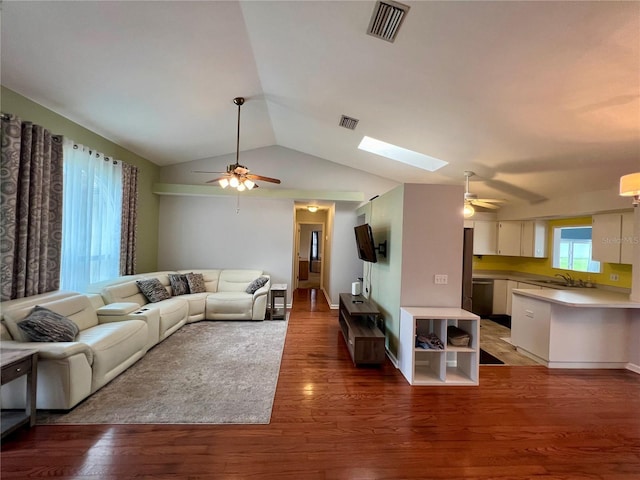 503 Philodendron, Punta Gorda, FL 33955 - living room featuring dark wood-style floors, vaulted ceiling with skylight, visible vents, and a ceiling fan