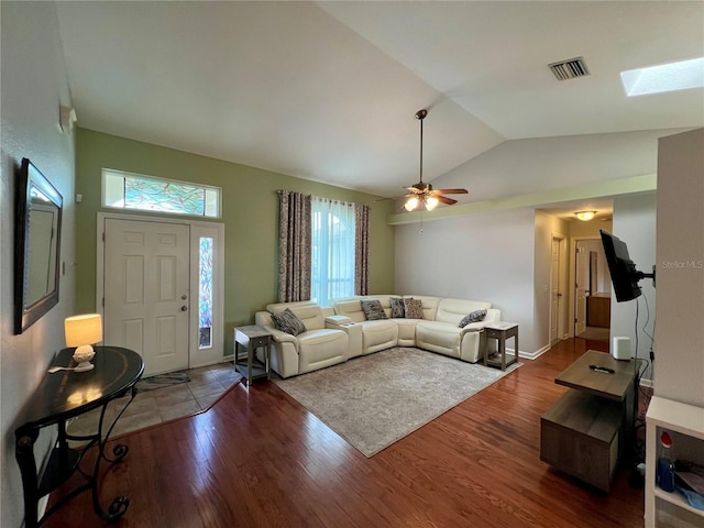 503 Philodendron, Punta Gorda, FL 33955 - living room featuring visible vents, ceiling fan, wood finished floors, vaulted ceiling with skylight, and baseboards