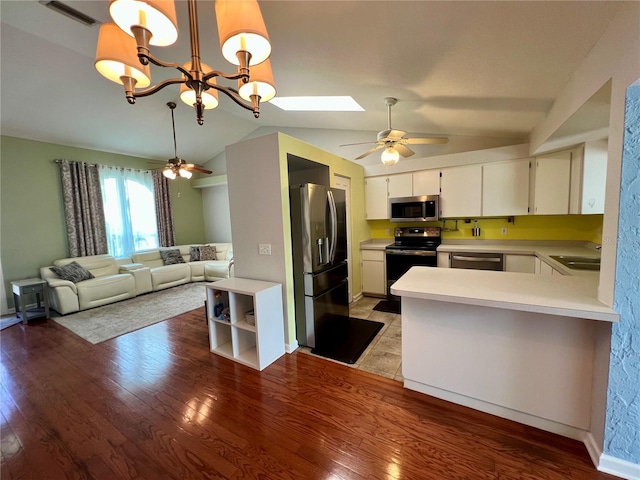 503 Philodendron, Punta Gorda, FL 33955 - kitchen with appliances with stainless steel finishes, open floor plan, hanging light fixtures, light countertops, and white cabinetry