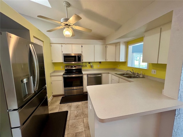 503 Philodendron, Punta Gorda, FL 33955 - kitchen featuring a peninsula, stainless steel appliances, light countertops, white cabinetry, and a sink