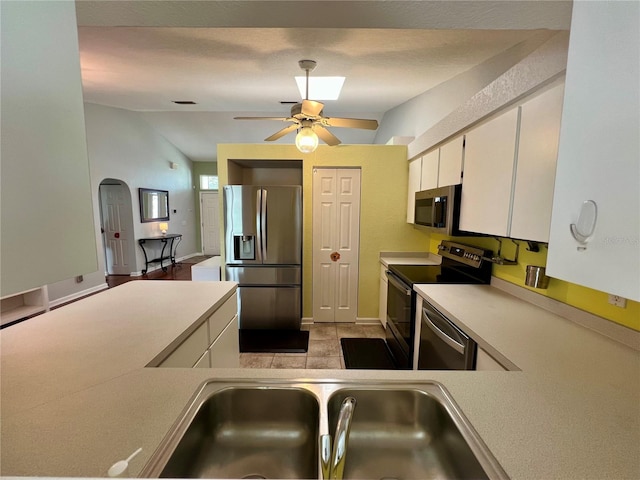 503 Philodendron, Punta Gorda, FL 33955 - kitchen with lofted ceiling, stainless steel appliances, a sink, white cabinetry, and light countertops