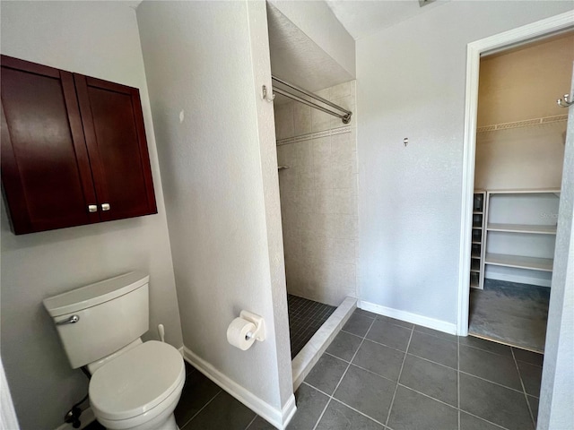 503 Philodendron, Punta Gorda, FL 33955 - bathroom with baseboards, a stall shower, toilet, and tile patterned floors