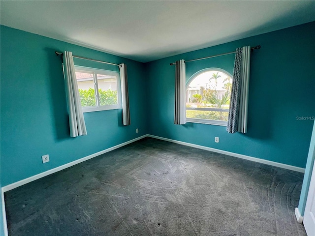 503 Philodendron, Punta Gorda, FL 33955 - unfurnished room featuring dark colored carpet and baseboards