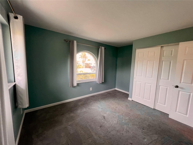 503 Philodendron, Punta Gorda, FL 33955 - unfurnished bedroom featuring baseboards, dark colored carpet, and a closet