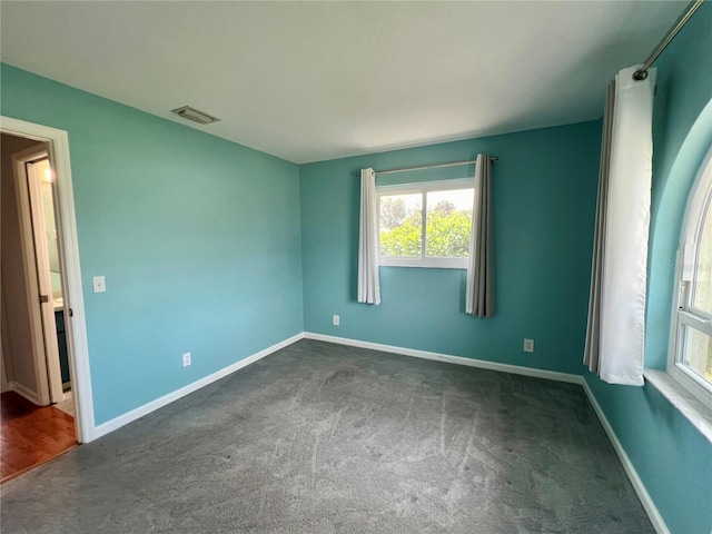 503 Philodendron, Punta Gorda, FL 33955 - empty room with baseboards, visible vents, and dark carpet