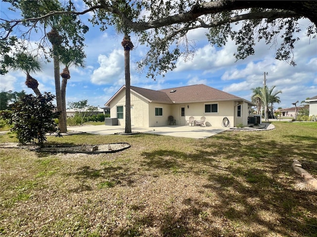 503 Philodendron, Punta Gorda, FL 33955 - rear view of house featuring a patio area, central AC unit, a lawn, and stucco siding