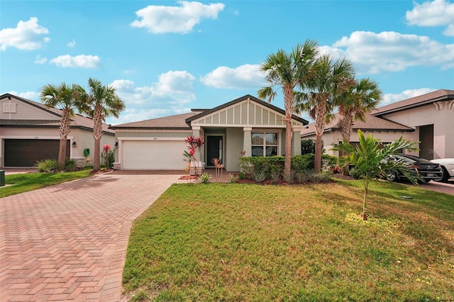 ranch-style house with an attached garage, decorative driveway, a front lawn, a porch, and stucco siding