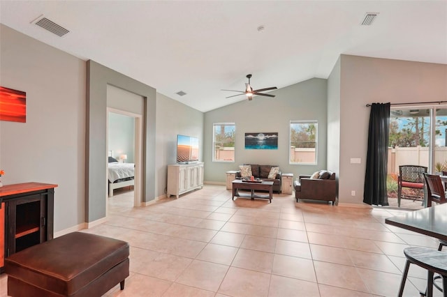 living room featuring a healthy amount of sunlight, visible vents, and light tile patterned flooring