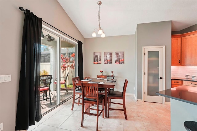 dining room featuring lofted ceiling, light tile patterned floors, baseboards, and an inviting chandelier