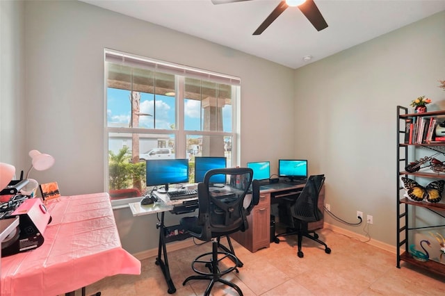 office space with ceiling fan, baseboards, and light tile patterned flooring