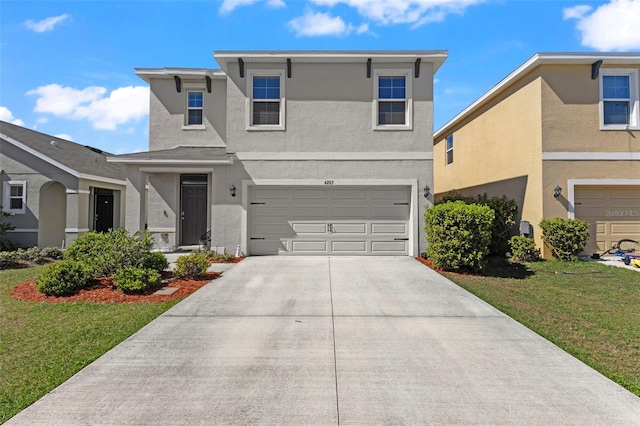 view of property with a front yard and a garage