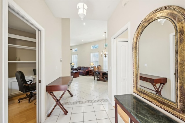 hall featuring an inviting chandelier and light tile patterned floors