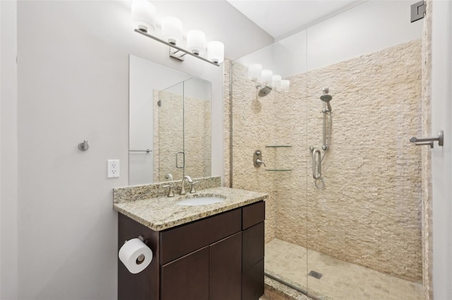 bathroom featuring a stall shower and vanity