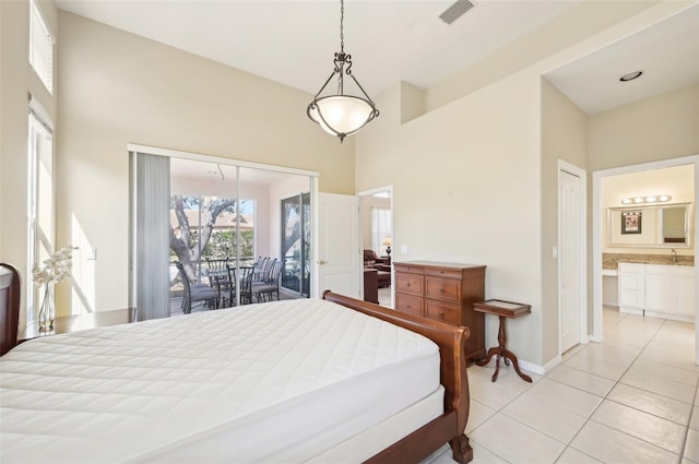 bedroom with light tile patterned floors, ensuite bathroom, visible vents, baseboards, and access to outside