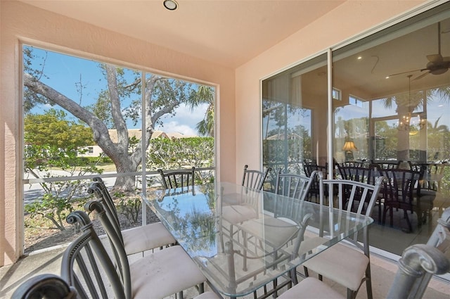 sunroom featuring ceiling fan