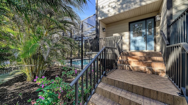 property entrance with an outdoor pool