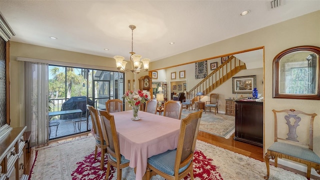 dining space featuring a notable chandelier, recessed lighting, visible vents, stairway, and light wood-style floors