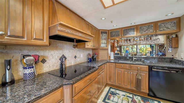 kitchen with black appliances, a sink, glass insert cabinets, and brown cabinets