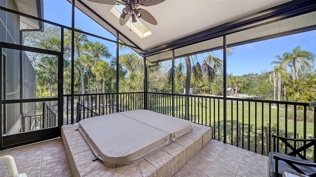 sunroom featuring lofted ceiling, ceiling fan, and a wealth of natural light