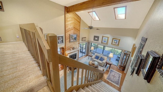 stairs featuring high vaulted ceiling and beamed ceiling