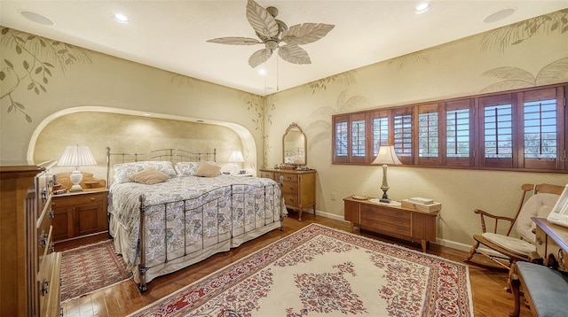 bedroom featuring ceiling fan, baseboards, wood finished floors, and recessed lighting