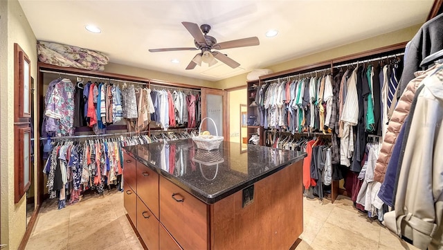 walk in closet featuring a ceiling fan