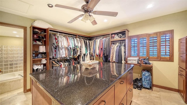 spacious closet featuring attic access and a ceiling fan