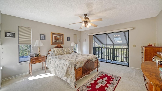 bedroom with access to exterior, light colored carpet, a textured ceiling, and baseboards