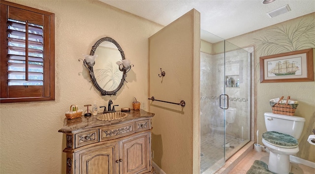 full bath with visible vents, a stall shower, vanity, and toilet