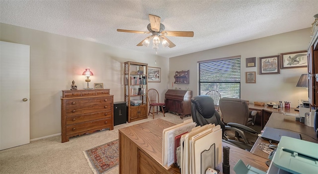 office with a textured ceiling, a ceiling fan, and light colored carpet