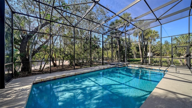 view of swimming pool with a lanai, a pool with connected hot tub, and a patio